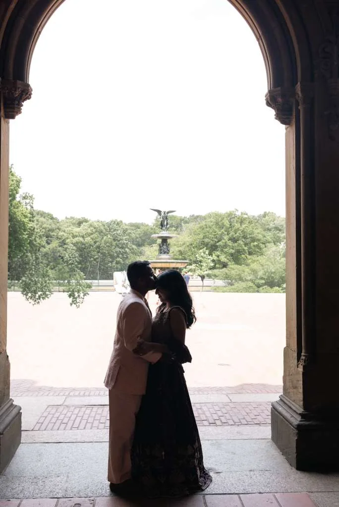 Justin and Angel silhouetted beneath an arch